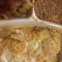 Huevos Ranchero · Any style eggs with ranchero sauce and served with bacon. Served with beans, potatoes and 2 ...