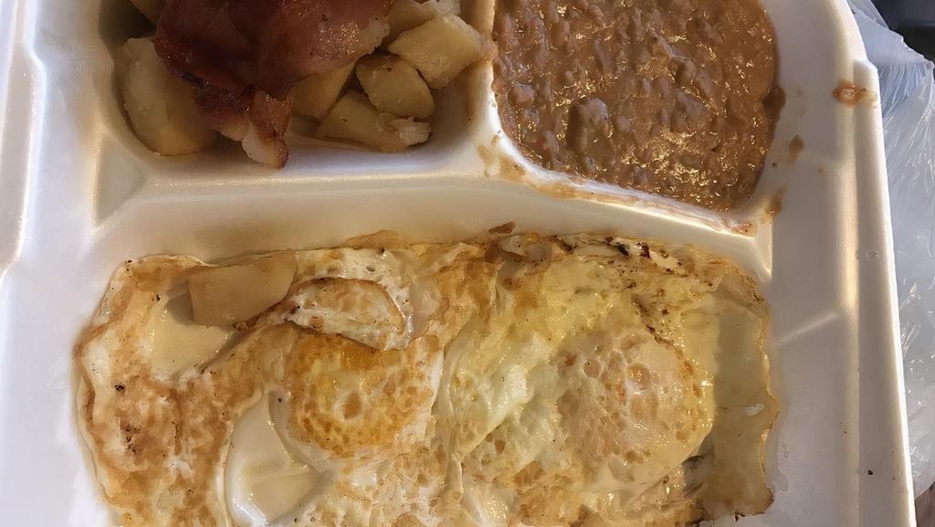 Huevos Ranchero · Any style eggs with ranchero sauce and served with bacon. Served with beans, potatoes and 2 tortillas