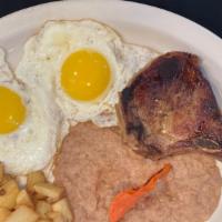 Pork Chops And Eggs Plate · Served with two eggs, refried beans, potatoes and ranchero sauce
