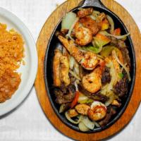 #13. Texan Fajitas · Grilled Beef, chicken & shrimp with bell peppers, onions, served with beans, rice, guacamole...