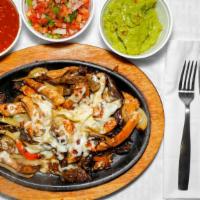 #25. Fajita Flameada · Grilled fajita covered with melted cheese. Served with rice, beans & guacamole salad.