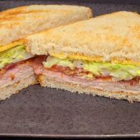 Up In The Club · Oven Roasted Turkey Breast, Honey Ham, and thick-cut Bacon are the stars of this classic san...