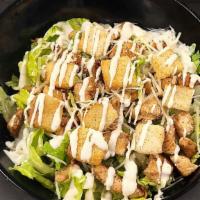 Chicken Caesar Salad · Grilled Chicken Breast, shredded Parmesan cheese and Croutons, served on a bed of Romaine. S...