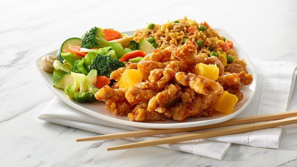 Orange Chicken · Battered chicken tossed in a tangy orange sauce, served with mixed vegetables and your choice of rice or noodles. (890-1100 Cals)