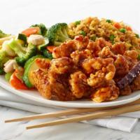 General Tso Chicken · Battered Chicken tossed in a sweet and slightly spicy sauce, served with mixed vegetables an...