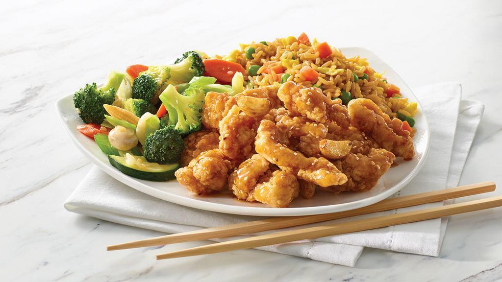 Honey Garlic Chicken · A sweet and savoury fusion of battered chicken, real honey and garlic served with mixed vegetables and your choice of rice or noodles. (930-1140)