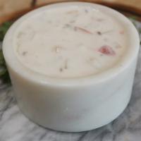Raita · A whipped yogurt sauce with carrots, cucumbers, tomatoes, onions and cilantro