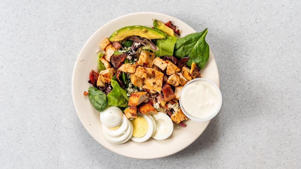 Cobb Salad · Chicken breast, hard-boiled egg, bacon, avocado, and tomatoes on iceberg lettuce topped with blue cheese.