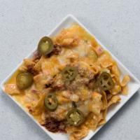 Frito Pie · Fritos smothered in chili, cheese, tomatoes, onions, and sour cream.