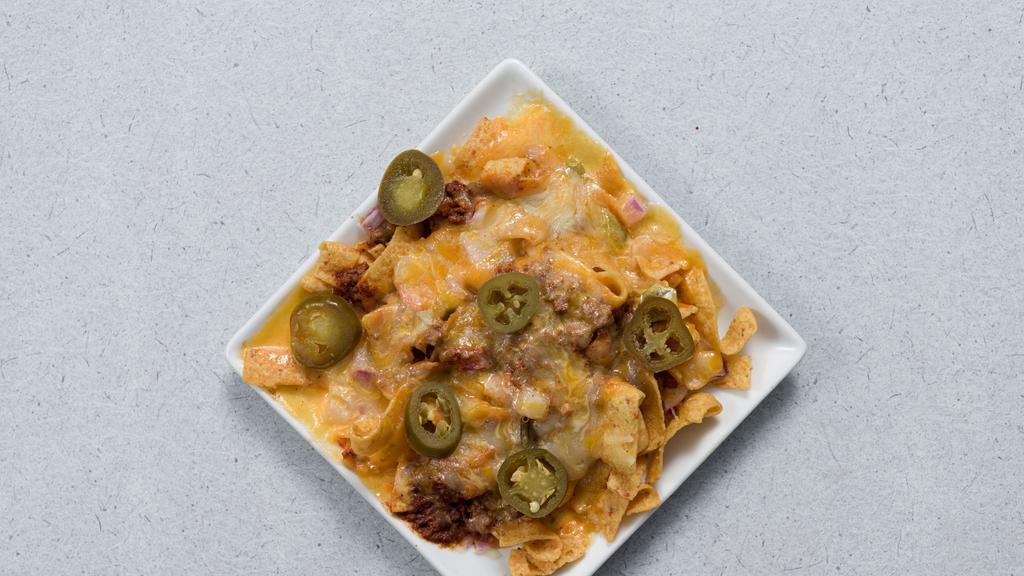 Frito Pie · Fritos smothered in chili, cheese, tomatoes, onions, and sour cream.