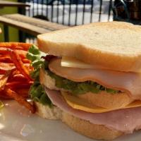 Club Sandwich · Ham, turkey, bacon, swiss cheese, American cheese with lettuce and tomato.