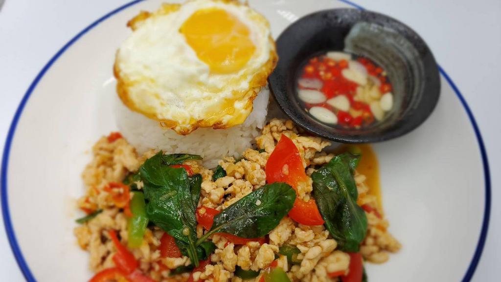 Krapow Kai Dow · Spicy. Choice of chicken, tofu, Beef or shrimp, served with steamed rice. Stir fry meat with garlic, Thai chili, green bean, Thai basil, hot spices, top with fried egg on top, and cucumber on side.