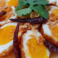 Son-In-Laws Eggs · Served with steamed rice. Fried boiled eggs, with our house tamarind sauce, on top with frie...
