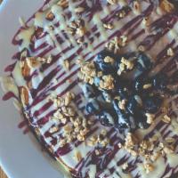 Solo Blueberry Streusel · Blueberries, sweet cream cheese glaze, 
blueberry coulis, créme anglaise, granola (all toppi...