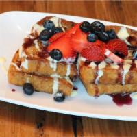 Petit Berry Dream French Toast · Vegetarian. Sliced brioche stuffed with sweet cream
cheese glaze, topped with blueberry coul...