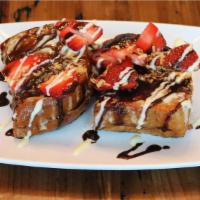 Petit Sweet Stuff French Toast · Vegetarian. Sliced brioche stuffed with sweet cream
cheese glaze, topped with chocolate,
str...