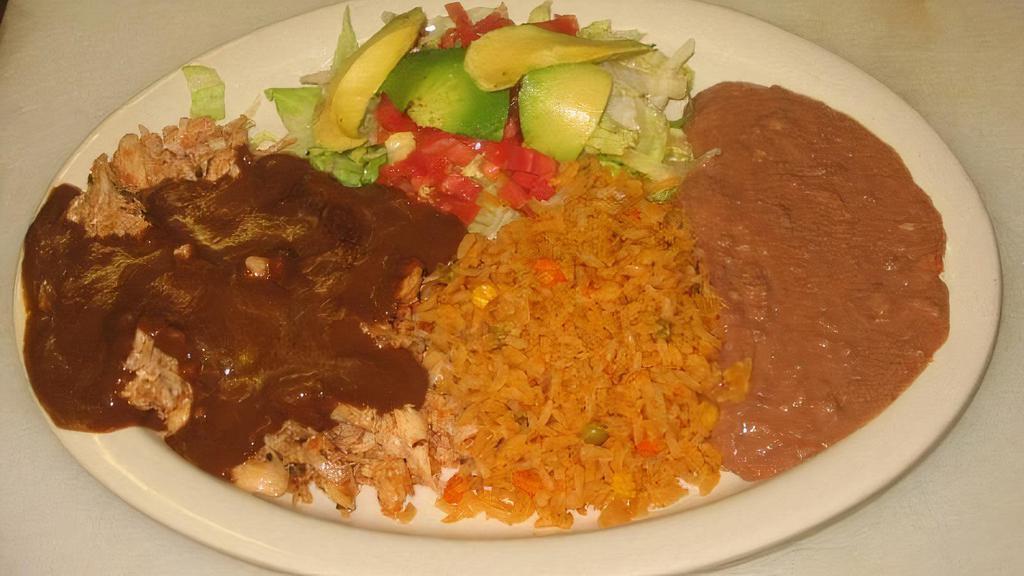 Chicken Mole · Shredded chicken topped with mole sauce, served with lettuce, our cream, pico de gallo, rice, refried beans, and tortillas.