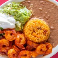 Camarones Rancheros · Grilled shrimp topped with chipotle sauce, served with lettuce, tomato, sour cream, rice, re...