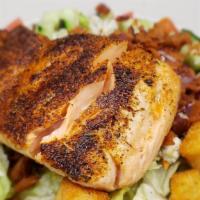 Blackened Salmon Cobb Salad · Blackened salmon, avocados, tomatoes, bleu cheese crumbles, bacon, cucumbers, and your choic...