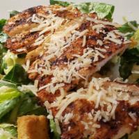 Blackened Chicken Caesar Salad · Blackened chicken breast on a bed of crisp romaine, garlic croutons, with grated parmesan.