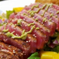 Ahi Tuna Salad · Blackened seared ahi tuna, diced red onion, mangos, cucumbers, crispy wontons, wasabi aioli ...