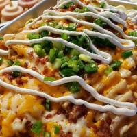 Loaded Fries · Seasoned waffle fries topped with cheese, crispy bacon, chives, sour cream, and jalapenos.