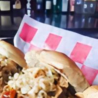Pulled Pork Sliders · Slow roasted pork, topped with jacks BBQ sauce and spicy coleslaw.