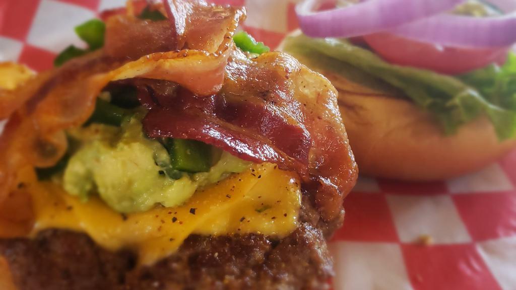 Guacamole Burger · BURGER TOPPED WITH GUACAMOLE, BACON, FRESH JALAPENOS, JACK CHEESE & CHIPOTLE MAYO. WITH LETTUCE, TOMATO, PICKLES, AND ONION