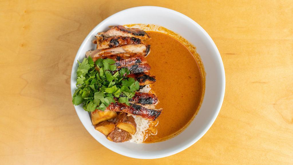 Kap'S Chicken Curry · A rich, panang curry with coconut, lemongrass, garlic, roasted chicken, potato and cilantro.