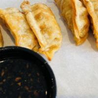 Fried Dumplings · Pork and vegetable dumplings served with a house-made soy and ginger dipping sauce.
