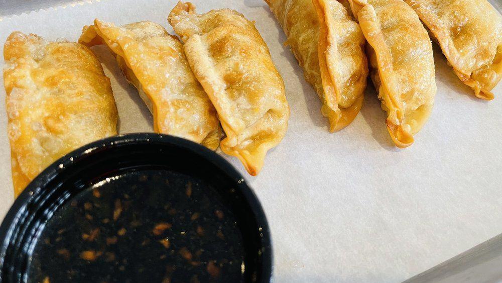Fried Dumplings · Pork and vegetable dumplings served with a house-made soy and ginger dipping sauce.