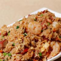 Yang Chow Fried Rice · Stir-fried rice with BBQ pork, shrimp, peas, carrots and onions.