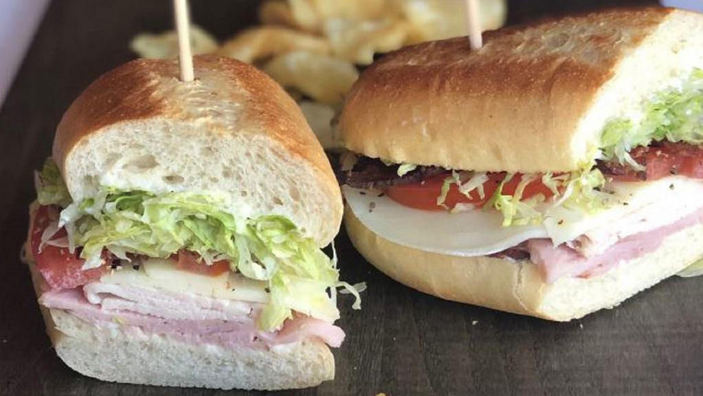 Club (Half) · With soup or salad. Roasted turkey, black forest ham, bacon, tomato, lettuce, mayo, provolone.