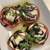 Mozzarella Caprese · Tomatoes with fresh mozzarella with olive oil and balsamic vinegar, basil and capers.