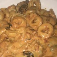 Tortellini Michel Angelo · Sautéed in a creamy pink sauce with artichokes and mushrooms.Includes salad and two garlic r...