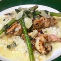 Salmon Scarpiello W/ Shrimp · Served over Risotto, in a  garlic lemon butter sauce topped with asparagus and shrimp.
Inclu...