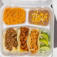 Taco Plate · Three tacos with your choice of meat served with side of rice, beans, cilantro, onion and li...