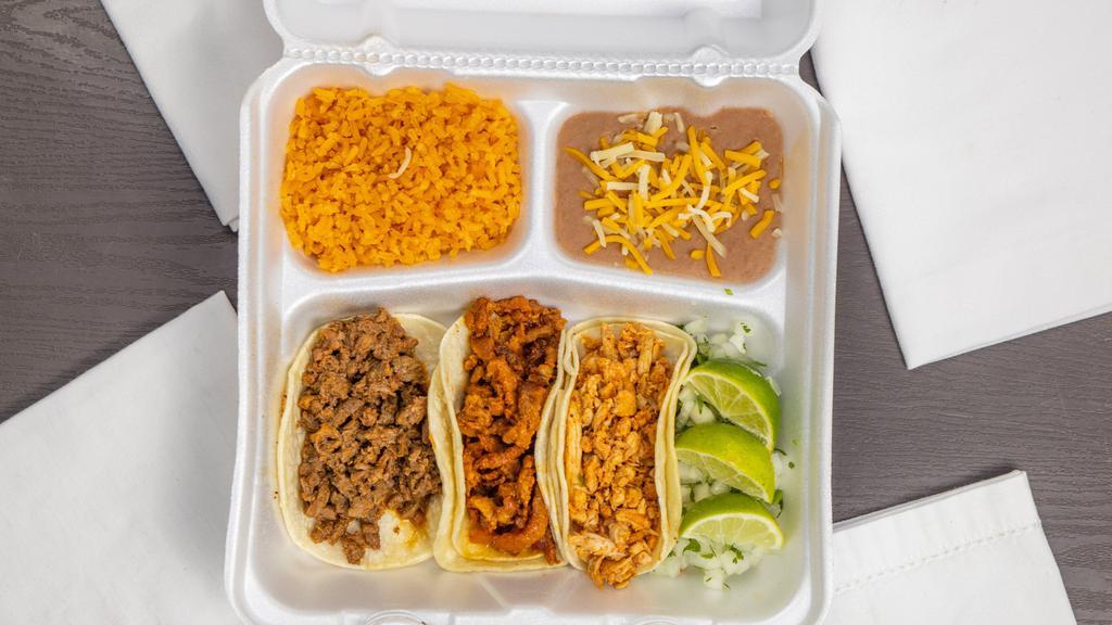 Taco Plate · Three tacos with your choice of meat served with side of rice, beans, cilantro, onion and limes.