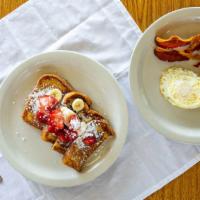 French Toast Platter · Two slices of sourdough bread grilled and topped with powdered sugar served with two eggs an...