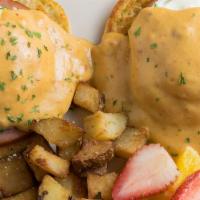 Southwestern Benedicts · Two poached eggs, Canadian bacon and chipotle hollandaise sauce on an English muffin.