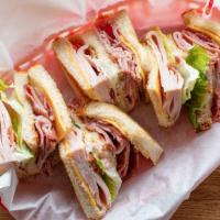 Triple Decked Club · Honey bee ham, turkey, bacon, cheese, triple stacked with lettuce and tomato.