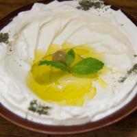 Labneh · Traditional Labneh garnished with olive oil & dried mint.