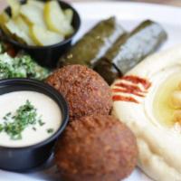 Mediterranean Falafel · Served with four pieces of falafel and two side with tahini sauce and pickles.