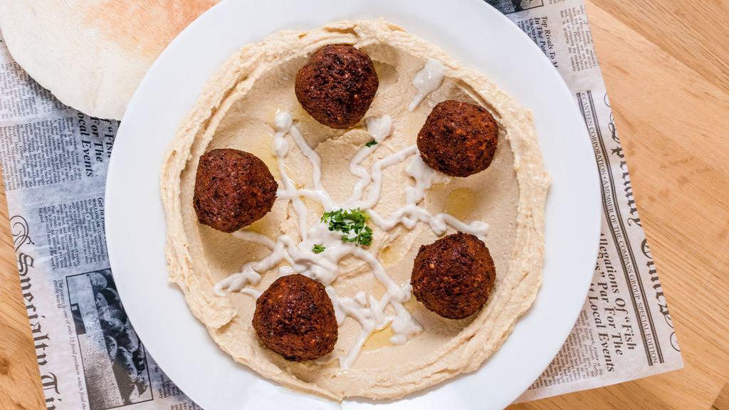 Hummus Plate · House made hummus served with a fresh in house made pita
OPTIONAL: Add 5 freshly made balls of falafel ($3.99)