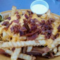Loaded Cheese Fries · Seasoned golden fries covered with shredded, melted Cheddar cheese, bacon, chives & jalapeno...