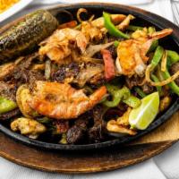 Parrillada Para 1 · Beef and chicken fajita, sausage, and shrimp sautéed with green bell peppers and onions. Acc...