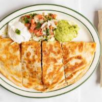 Quesadillas · Grilled flour tortillas Stuffed with Monterey cheese, your choice of meat served with sour c...