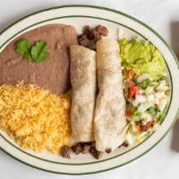 Two Tacos Al Carbon · Two fajita taco filled with your choice of meat rolled in a flour tortilla.