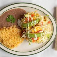 Shrimp Tacos. · Two shrimp tacos filled with lettuce, tomatoes, Queso Fresco, Sliced Avocado and with a Crea...