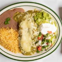 Enchiladas Verdes · Two shredded chicken enchiladas topped of with a green tomatillo sauce melted Monterey Jack ...